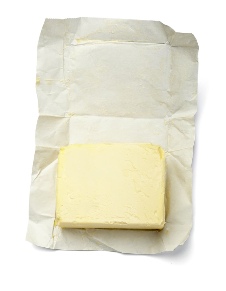 unwrapped butter on white background with clipping path