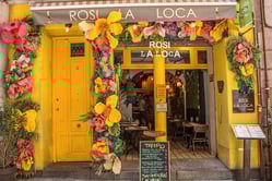 A store filled with lots of yellow flowers

Description automatically generated