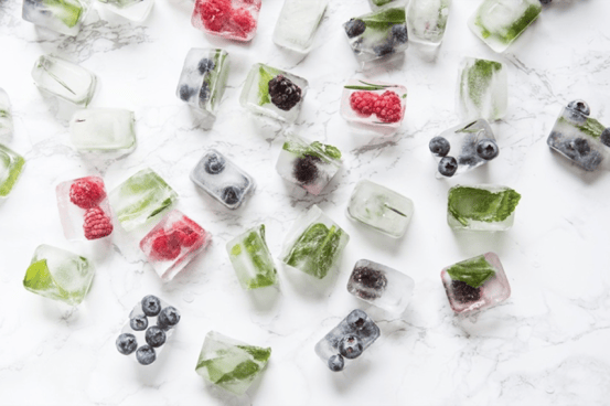 Picture of ice cubes with mint and berries in them.