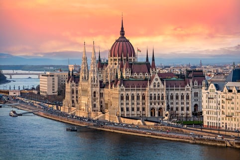 the-hungarian-parliament-on-the-danube-river-at-sunset-in-budapest--hungary-945207010-23afbc9012d54bc4bb7c8a1f8c90075b